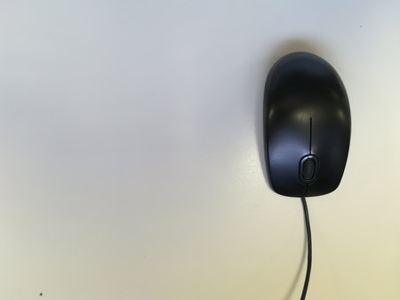 black desktop computer cable mouse on a white background, placed on the right side of the image.