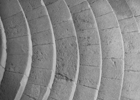 geometric detail of curved stairs in light gray colors of granite rock. with rectangular rock blocks.の写真素材