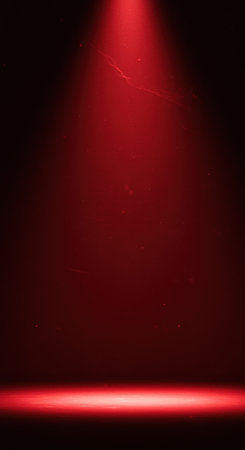 Red stage spotlight on a dark background. Place for your text.の素材