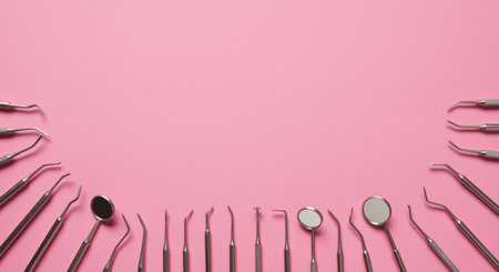 Dental tools on pink background, top view with copy space.の素材