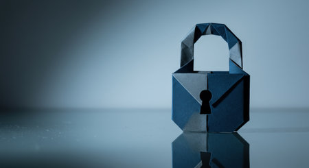 Dark blue origami padlock with keyhole on reflective surface, paper security icon symbolizing privacy, data protection and cybersecurity.の素材