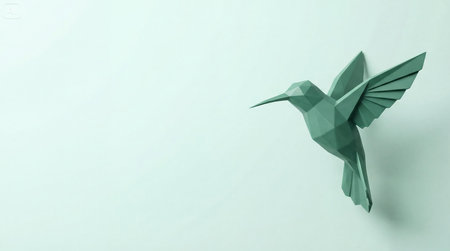 Geometric Paper Hummingbird Attached to a Light Teal Wall, Showing a Modern and Minimalist Designの素材