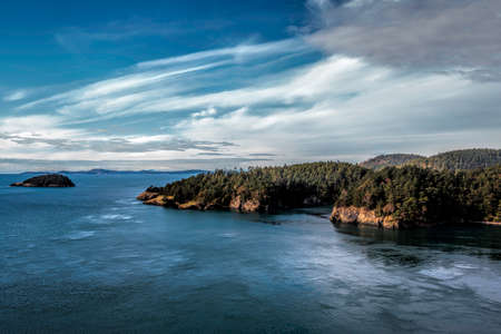 View of Deception Pass from the bridge with blue sky and water.  Washington Stateの写真素材