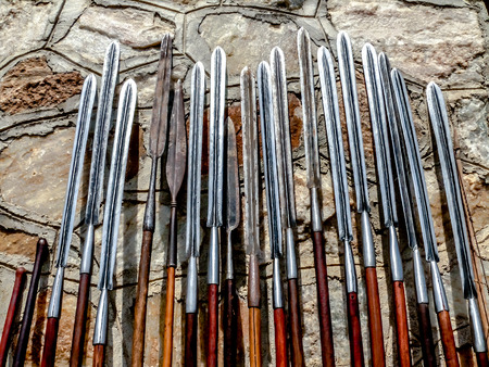 Masai spears resting against a stone wall, made the original way as they have alwasy been made.の写真素材