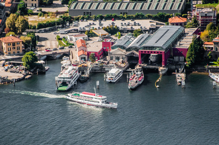 Ferry leaves from the harbour in lake Como at Como, Italy. Viewed from high above.のeditorial素材