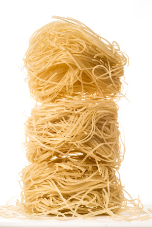 Three balls of very fine and thin spagehetti type pasta, known as Angelの写真素材