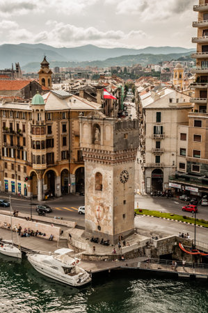 The harbour tower by the town of Savona is viewed from high above as it is seen with the town behind it.のeditorial素材