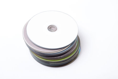 Many compact discs in a pile, one on top of the other.の写真素材