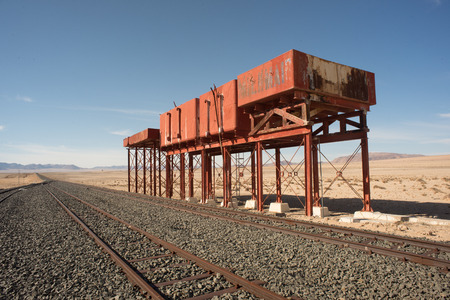 Derelict water tanks by the railroad tracks on the Railroad line to Luderitz from Aus.の写真素材