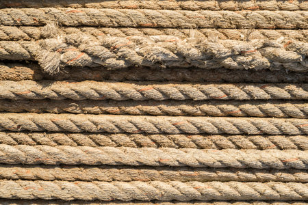 Natural rope made of fibre as background with knot in foreground.
