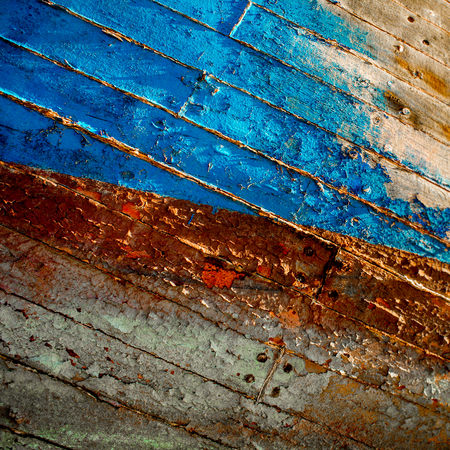 Paint peeling of the side of an old wooden boat.の写真素材