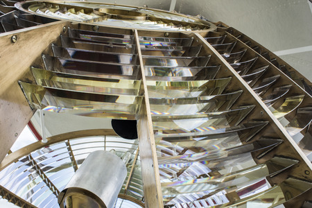 An up close view of the light of a lighthouse with the bulbs on the inside of the light also visible.の写真素材