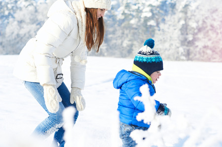 Lovely family having fun outdoor - snowy woodlandの写真素材