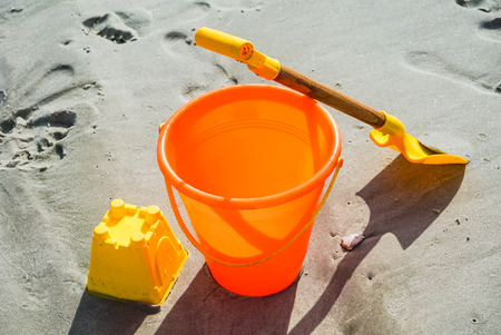 Ready to build a sandcastle with this shovel and pail on the beachの写真素材