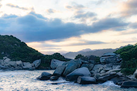 A pile of snow next to a rockの写真素材