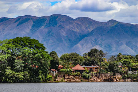 A body of water with a mountain in the backgroundの写真素材