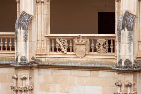 Toledo, Spain. August, 2020. A family wearing face mask to avoid Covid-19 takes photos and stares fixedly at the cloister of the Monastery of San Juan de los Reyes in old town Toledo.のeditorial素材