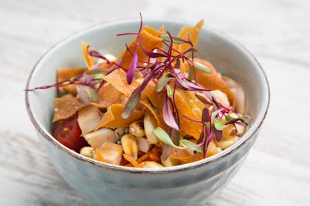 Close-up of bowl with salmon poke, typical Hawaiian salad, top view.