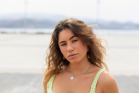 portrait of beautiful young woman looking at camera with blurred backgroundの写真素材