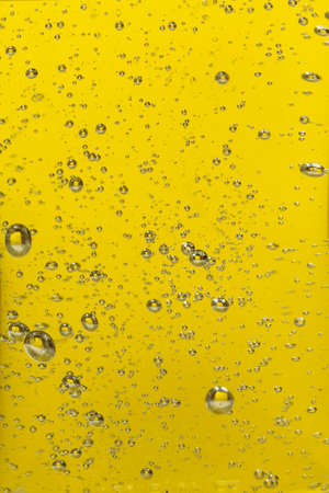 closeup of oil bubbles yellow backgroundの写真素材