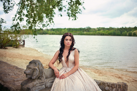 young beautiful bride woman in white dress outdoors on the natureの写真素材