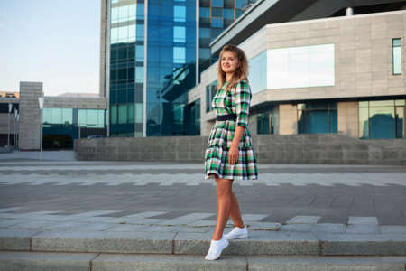 Happy woman in summer city in short dressの写真素材