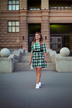 Happy woman in summer city in short dress
