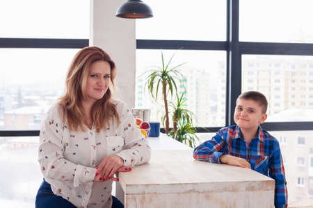 Middle-aged woman mom with daughter and son in the light roomの写真素材