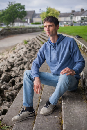 joyful middle-aged man in nature on a warm sunny dayの写真素材