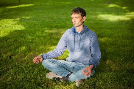joyful cheerful man in nature on a warm sunny dayの写真素材
