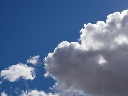 Vibrant blue sky with fluffy cloudsの写真素材