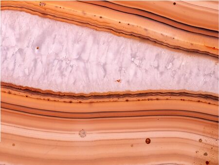 Backlighted sliced agate rock with crystals and layersの写真素材