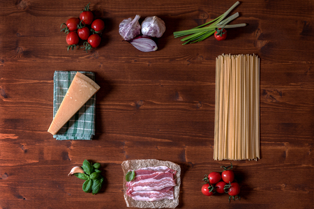 Italian pasta dish with basil, garlic,onion, bacon and tomatoesの写真素材