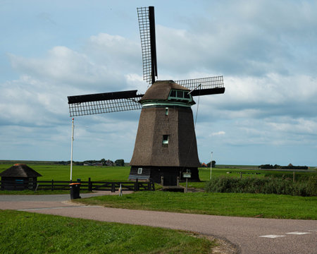 Windmill on agriculture farmland landscape in Petten (The Netherlands)の写真素材