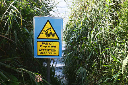 Deep water warning sign in a park (Haarlemmermeerse Bos)の写真素材