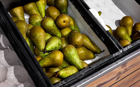Pears in a fruit basket being displayed in a supermarket