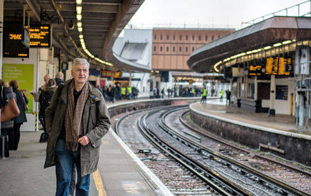 London, UK - March 9, 2016: London Bridge Railway Station, Man On Platform Waiting For Train.のeditorial素材