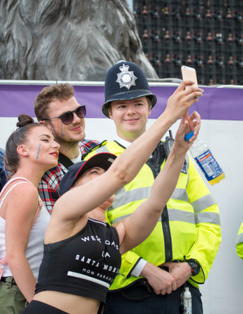 London, UK - June 25, 2016: Pride Parade, People Taking Selfie With Police Officer