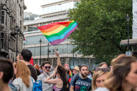 London, UK - June 25, 2016: LGBTQ Gay Pride Parade, Crowd Of People With Waving Rainbow Flag.