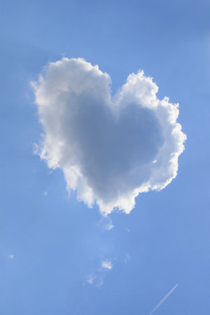 Naturally heart shaped cloud in a blue spring afternoon sky.の写真素材