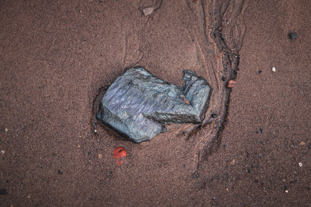 Traces in the Sand around a Stone
