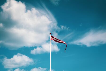 Danish Flag against blue cloudy Skyの写真素材
