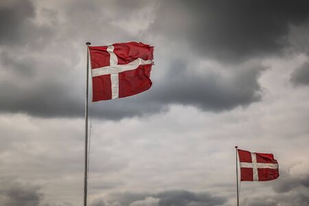 Danish Flag in front of a stormy Skyの写真素材