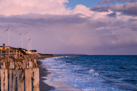 Sunset on the Beach of Juelsminde in Jutland Denmark. View along the sandy beach and of the Baltic Sea.の写真素材