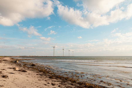 Wind turbines on the beach in Denmark at low tide in winter.の写真素材