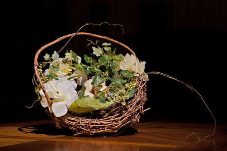 Easter eggs in wooden basket with flowerの写真素材