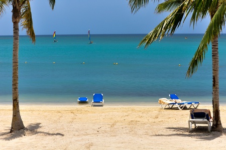 Beautiful caribbean lagoon with two colorful jolly boatsの写真素材
