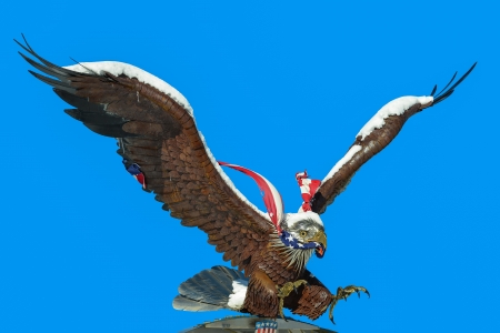 statue of eagle with usa flag in its beakの写真素材