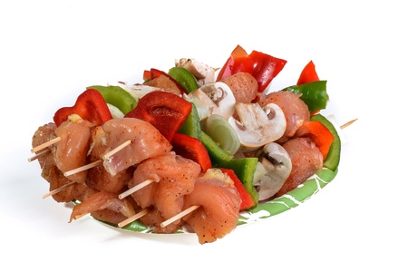Fresh flesh meat shashlik with vegetables isolated on whiteの写真素材