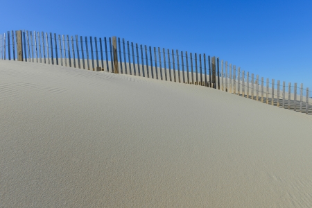 pretty beach with sand dune fence , north carolinaの写真素材